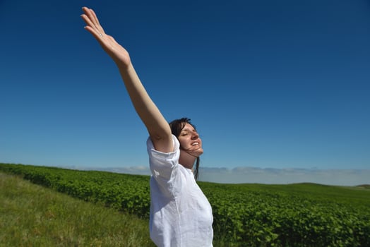 Young happy woman in green field photo