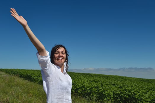 Young happy woman in green field photo