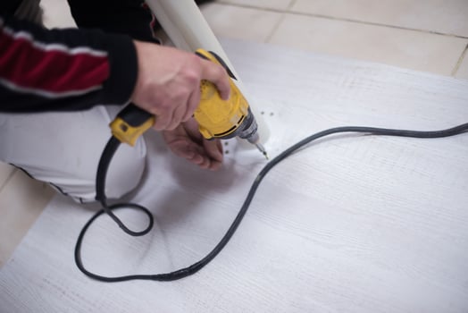 repairman working with drilling machine photo