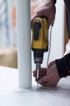 repairman working with drilling machine photo