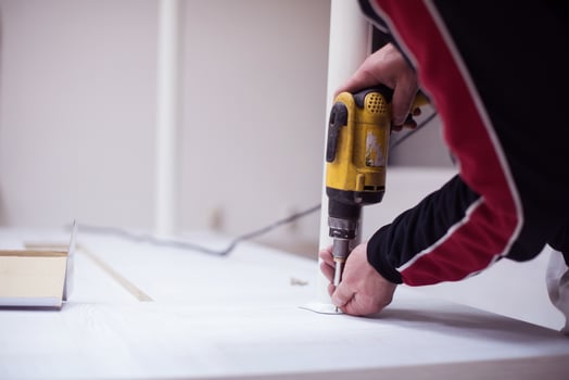 repairman working with drilling machine photo