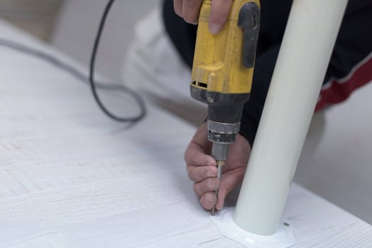 repairman working with drilling machine photo