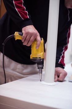 repairman working with drilling machine photo