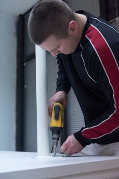 repairman working with drilling machine photo