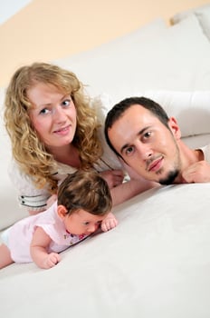 indoor portrait with happy young family and  cute little babby photo