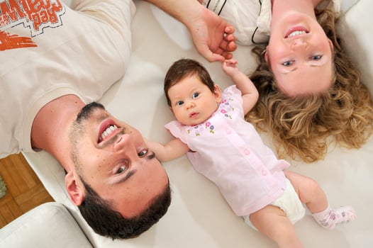 indoor portrait with happy young family and  cute little babby photo