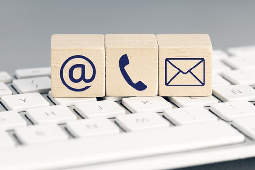 Contact us icons on wooden blocks on computer keyboard photo