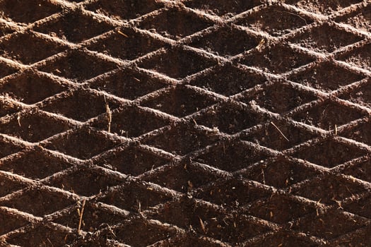 Canal cover surface texture. Rusty iron square pattern. Rusty metal square texture. Robust old iron rusted canal cover wallpaper. Ruststained canal grid form cover backdrop. photo