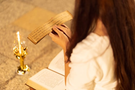 Asia woman wearing traditional dress of Thailand reading Sanskrit ancient Tripitaka book of Lord Buddha dhamma, Sanctuary Ratchanatdaram bangkok. in night photo