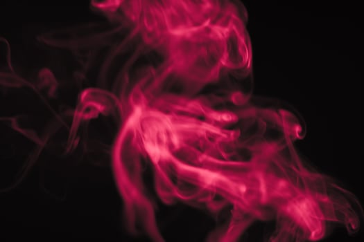 Red smoke in a dark room in a black background photo