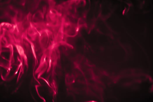 Red smoke in a dark room in a black background photo