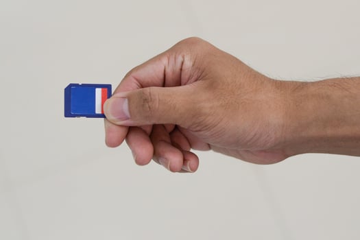 hand holding sd memory card. photo