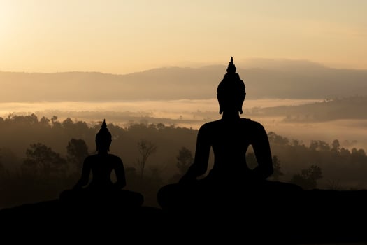 Silhouette Buddha on golden sunset background. photo