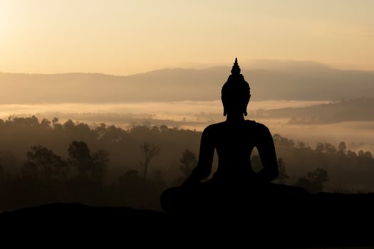 Silhouette Buddha on golden sunset background. photo
