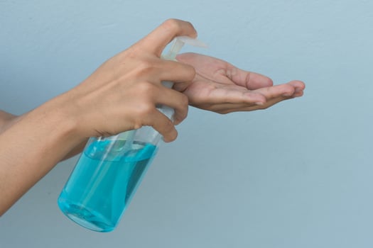 Woman holding alcohol gel in hand for wash prevent viruses and bacteria photo