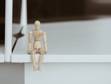 Wooden Man Lonely figure sitting alone photo