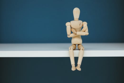 Wooden Man Lonely figure sitting alone photo