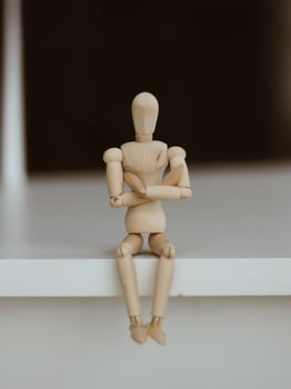 Wooden Man Lonely figure sitting alone photo