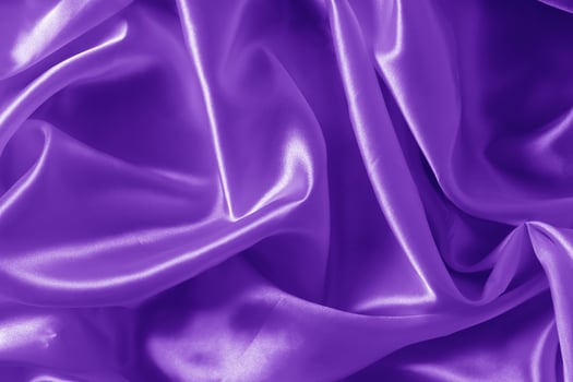The texture of the proton purple cloth with waves and shrugs. Shiny fabric. photo