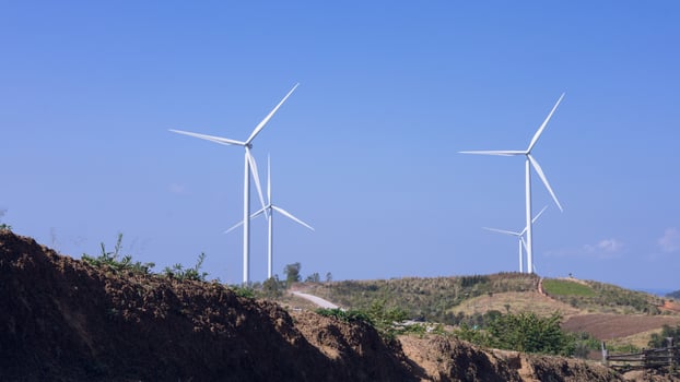 Offshore wind power and energy farm with many wind turbines on the mountain photo