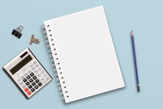 The notebook is set on a blue paper background. photo