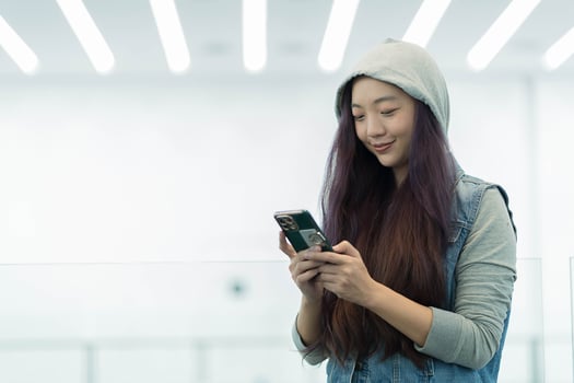 Young asian Woman use of cellphone at department store photo