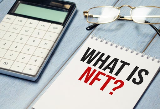 Paper with what is nft text on wooden background photo