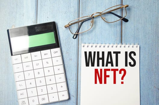 Paper with what is nft text on wooden background photo