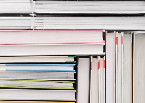 books stacked in a pattern. background for back to school concept. pile of hardcovered books photo