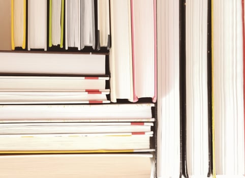 collection of hardcovered books stacked in a pile. pattern made of books. learning and study, literacy and education concept. photo
