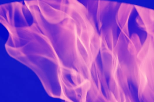 Abstract pink-violet reflections of light, flame, smoke, blurred on a blue background. Bright colored background. photo