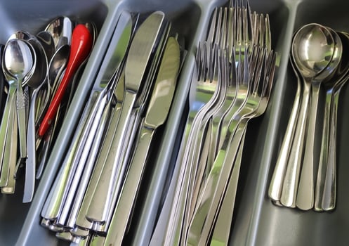 Selective focus of shiny cutlery in a dishwasher after cleaning. Forks, Knifes and Spoons photo
