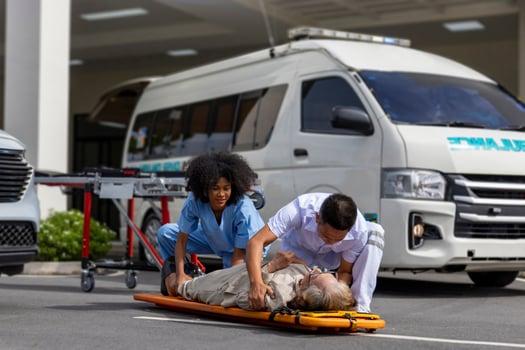 Team of paramedic is helping the senior patient from car crash by using spinal board to transfer into the ambulance for first aid and street accident concept photo