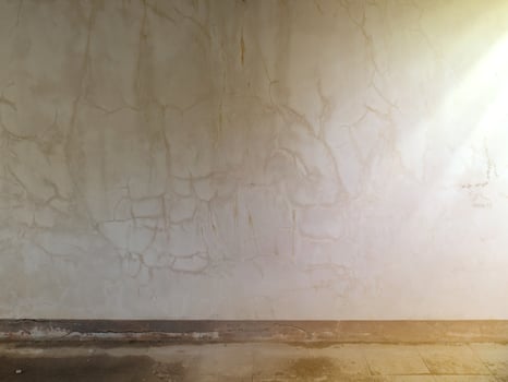The old wall background has cracks and light shines through it. photo