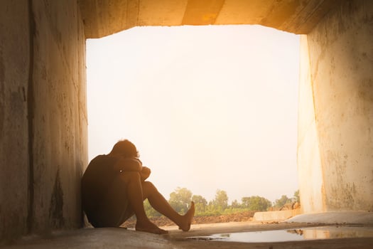 Asia you man sitting alone.He sitting in  under big tunnel.man very sad and depressed.sad,alone,suicide.despair. sickness.photo health and disappointment concept. photo