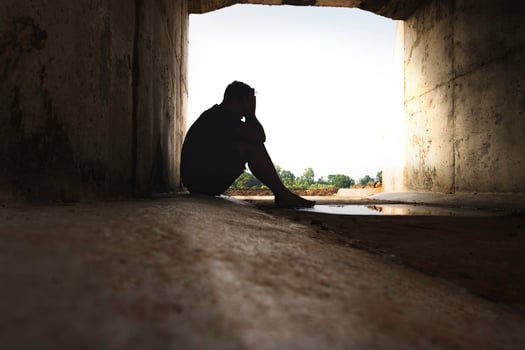 Asia you man sitting alone.He sitting in  under big tunnel.man very sad and depressed.sad,alone,suicide.despair. sickness.photo health and disappointment concept. photo