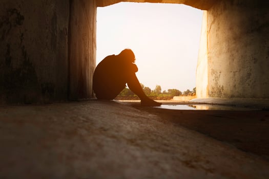 Asia you man sitting alone.He sitting in  under big tunnel.man very sad and depressed.sad,alone,suicide.despair. sickness.photo health and disappointment concept. photo