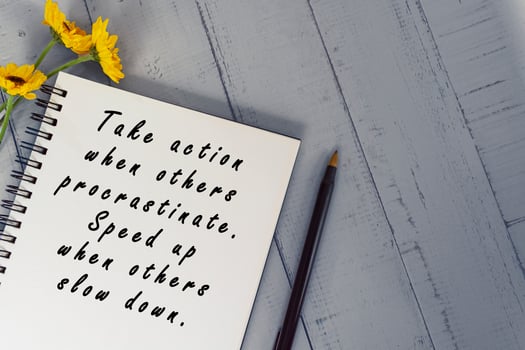 Motivational quote on note book with sunflowers on wooden desk. photo