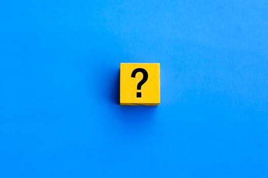 Cube with question mark on blue background. photo