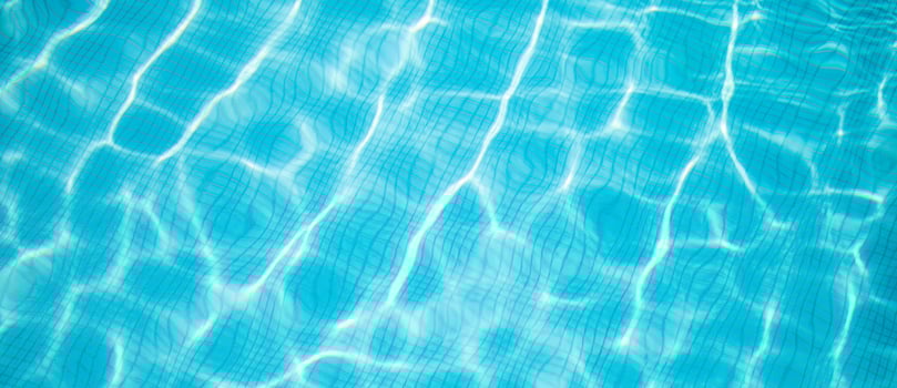 Surface of blue swimming pool, background of water in swimming pool. Summer fun, recreational outdoor activity, sunny blue water surface photo