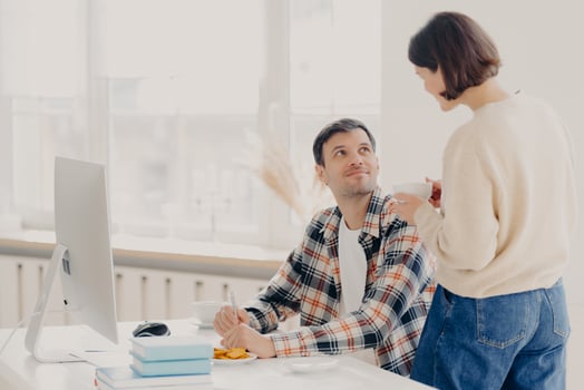 Family, paper work and technology concept. Husband and wife study contract agreement, read terms and conditions, discuss domestic bills, drinks coffee, man poses at desktop with modern computer photo