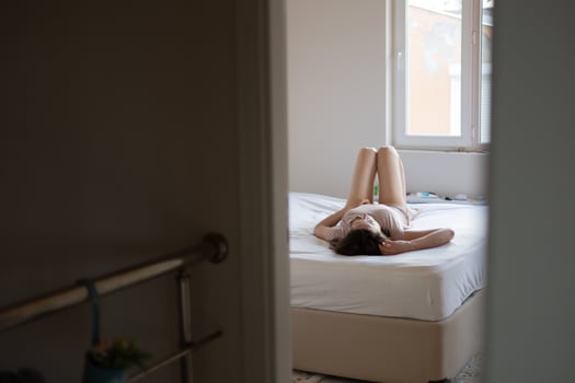The woman lies on the bed photo