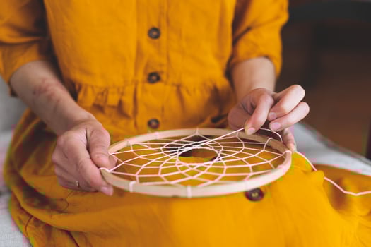 Woman making a dream catcher from threads photo