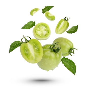Fresh green tomatoes with leaves on white background photo