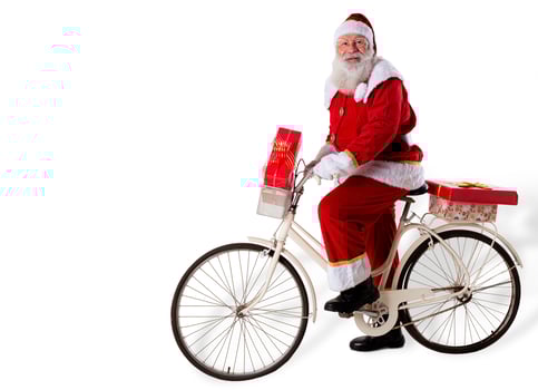 Santa Claus on bicycle delivering Christmas gifts. photo