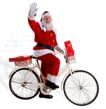 Santa Claus on bicycle delivering Christmas gifts. photo