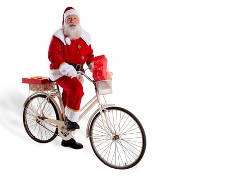 Santa Claus on bicycle delivering Christmas gifts. photo