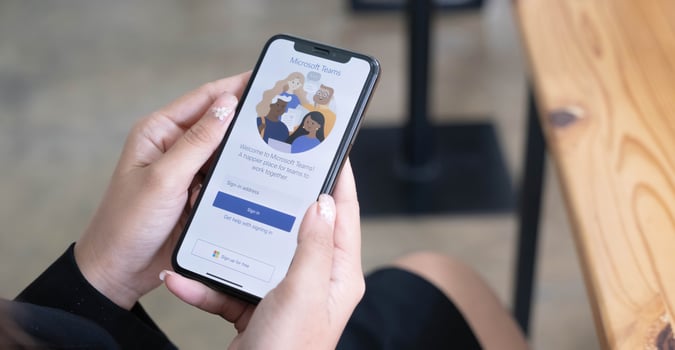 A working from home employee is downloading the Microsoft Teams social platform, ready for remote working in isolation from home photo