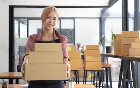 Female startup small business owner standing with smiles at camera. Online selling. E-commerce. photo