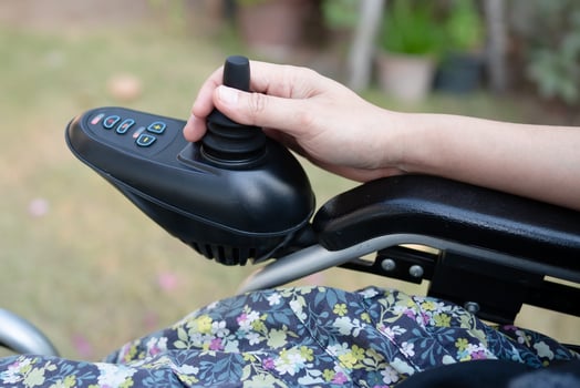 Asian lady woman patient on electric wheelchair with joystick and remote control at nursing hospital ward, healthy strong medical concept photo